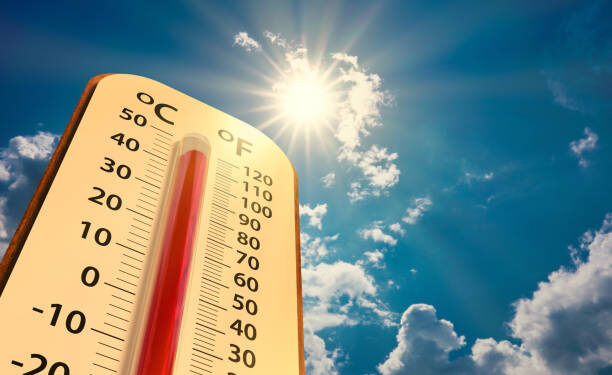 climate change, low angle view Thermometer on blue sky with sun shining in summer show increase temperature, concept global warming