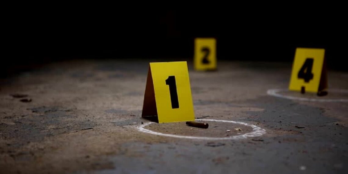 Wide pan of crime scene markers of bullet casings on a concrete floor